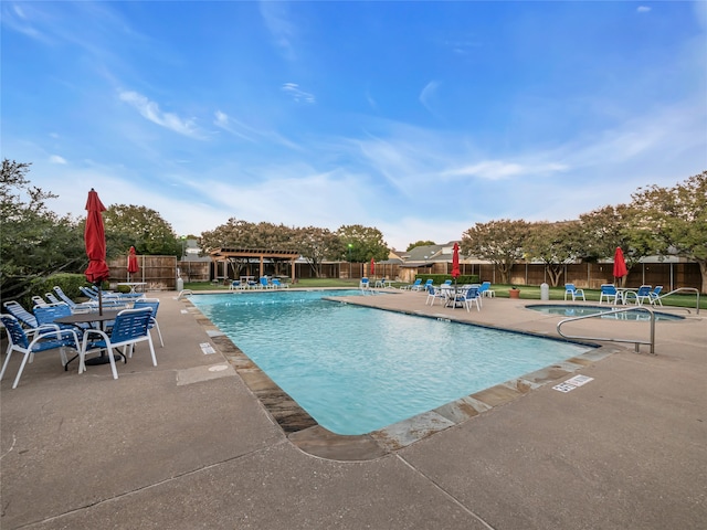 view of swimming pool with a patio area