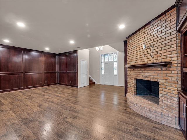 unfurnished living room with a fireplace and dark hardwood / wood-style flooring