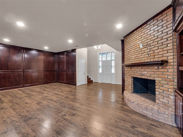 unfurnished living room with a fireplace and dark hardwood / wood-style flooring