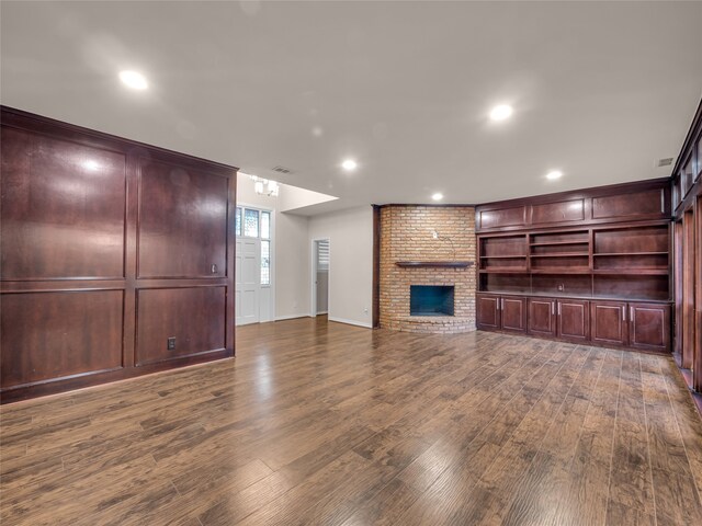 unfurnished living room with a fireplace and dark hardwood / wood-style flooring