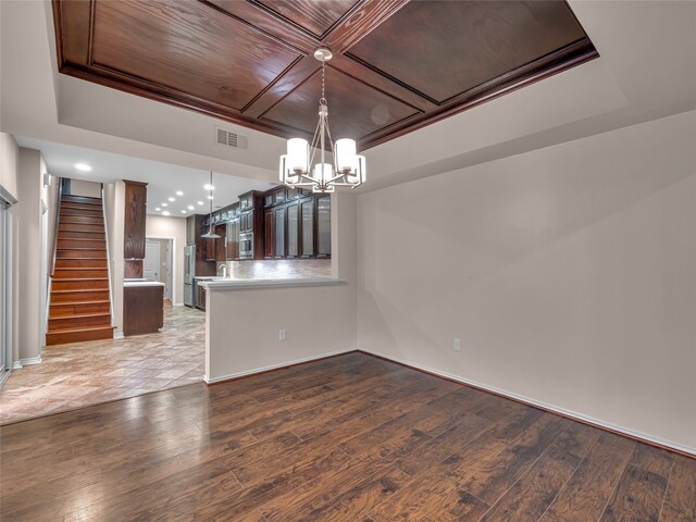 unfurnished dining area featuring light wood-type flooring, wood ceiling, and an inviting chandelier