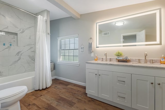 full bathroom with hardwood / wood-style flooring, shower / bath combination with curtain, toilet, and vanity