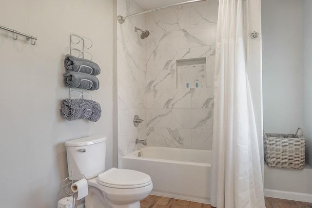 bathroom with hardwood / wood-style floors, shower / bath combination with curtain, and toilet