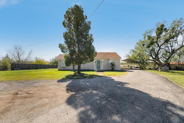 view of front of property with a front lawn and a carport