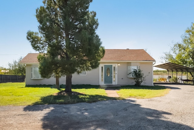 view of front facade with a carport and a front yard