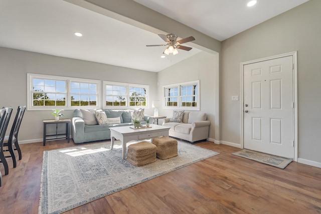 living room with ceiling fan, plenty of natural light, and wood-type flooring