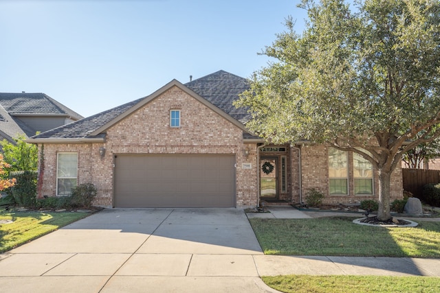 view of front of property with a front yard and a garage