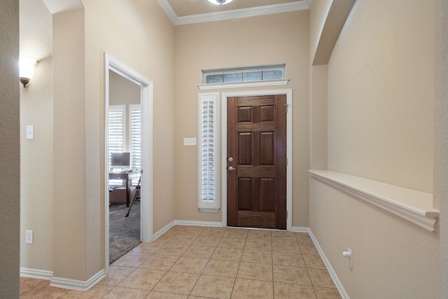 tiled foyer featuring ornamental molding