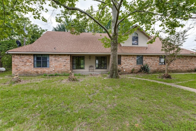 rear view of property featuring a yard