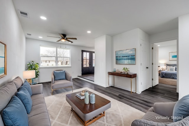 living room with hardwood / wood-style flooring and ceiling fan