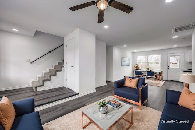 living room with dark hardwood / wood-style floors and ceiling fan