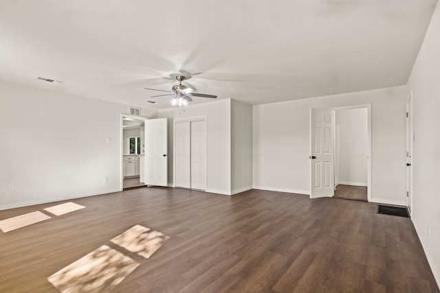 unfurnished room with ceiling fan and dark hardwood / wood-style floors