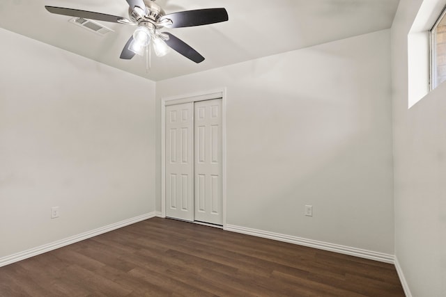 spare room featuring ceiling fan and dark hardwood / wood-style floors