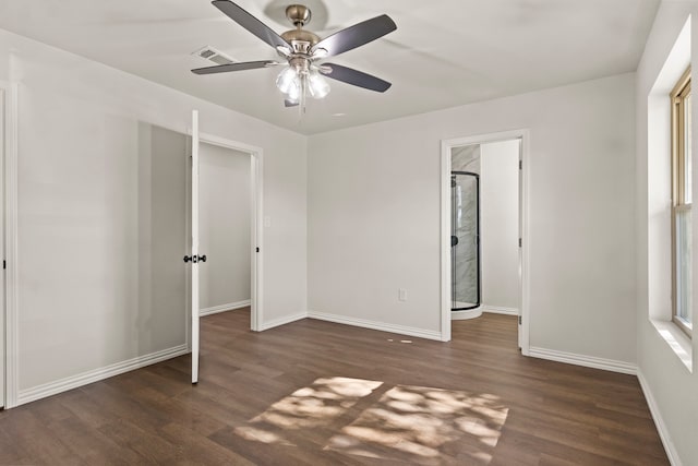 unfurnished bedroom featuring ceiling fan and dark wood-type flooring