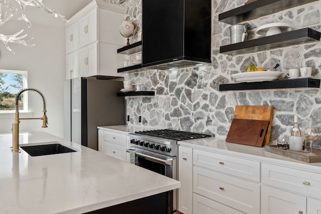 kitchen featuring sink, white cabinets, stainless steel appliances, and range hood