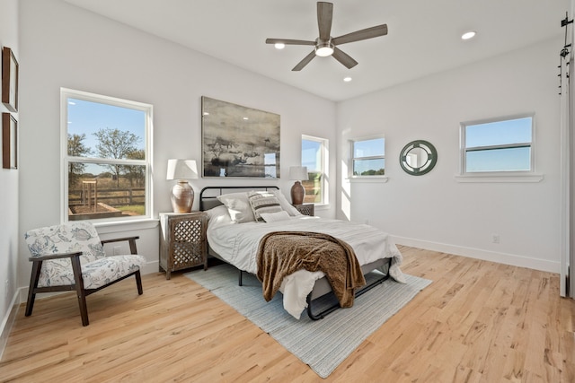 bedroom with ceiling fan and light wood-type flooring