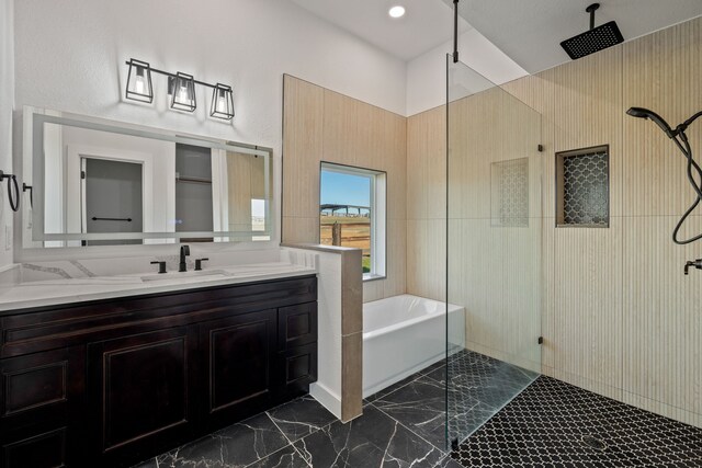 bathroom featuring shower with separate bathtub and vanity