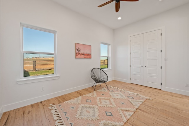 sitting room featuring hardwood / wood-style flooring and ceiling fan