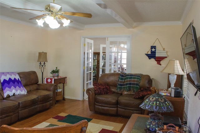 living room featuring a textured ceiling, ceiling fan, crown molding, light hardwood / wood-style flooring, and beamed ceiling