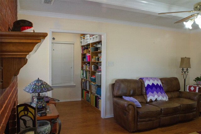 living room with hardwood / wood-style floors, ceiling fan, and ornamental molding