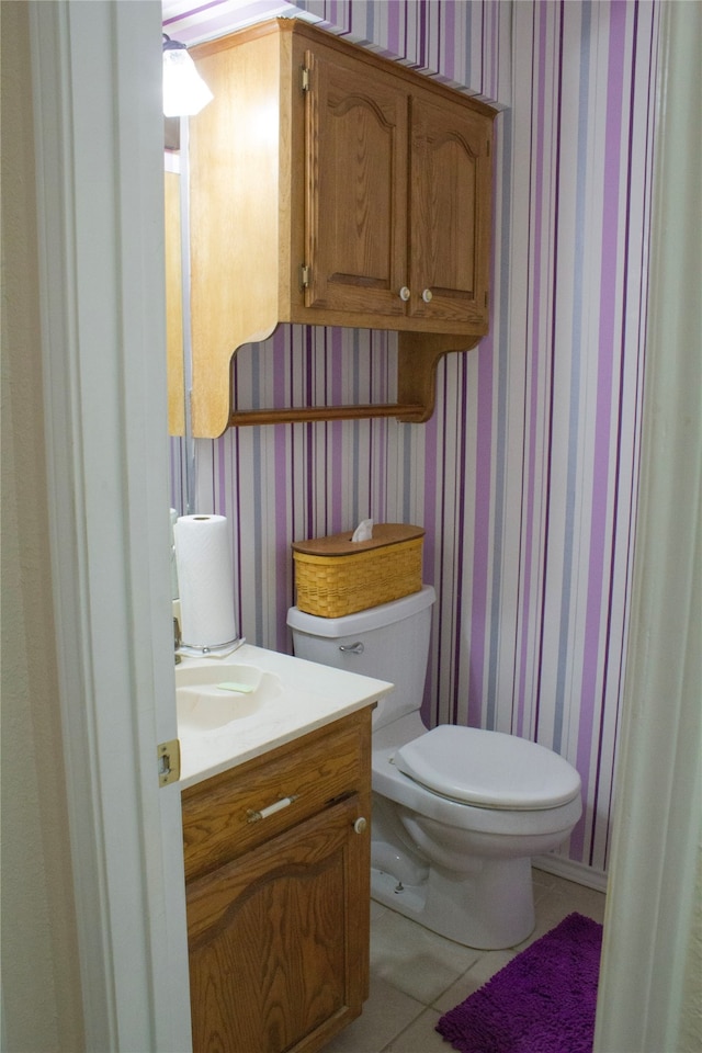 bathroom featuring toilet, vanity, and tile patterned floors