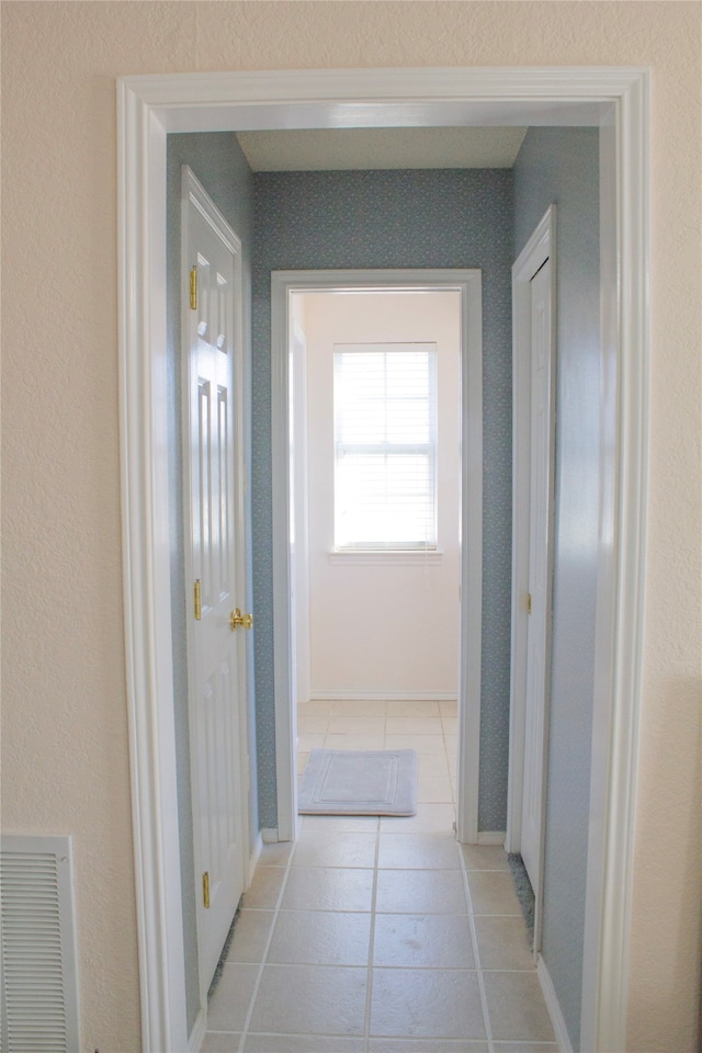 hallway with light tile patterned floors