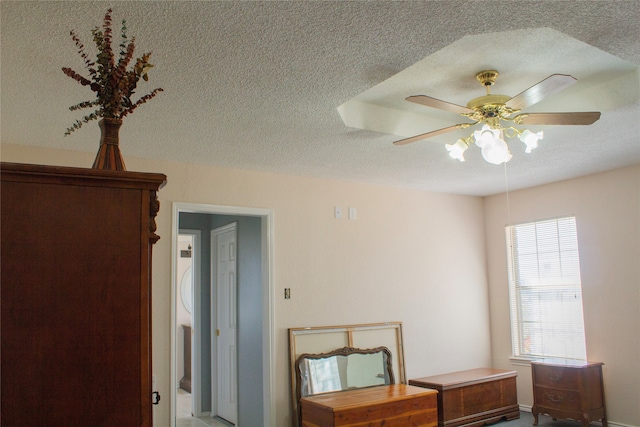 bedroom with a textured ceiling and ceiling fan