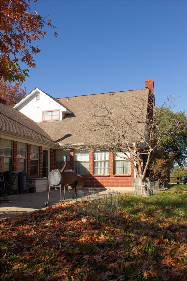 rear view of property featuring a patio area