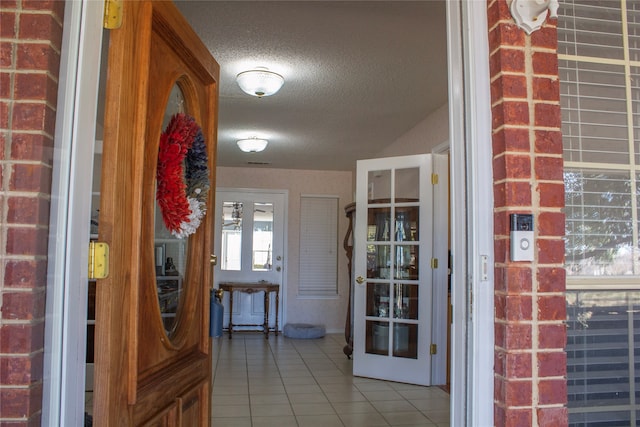 interior space featuring tile patterned floors and a textured ceiling