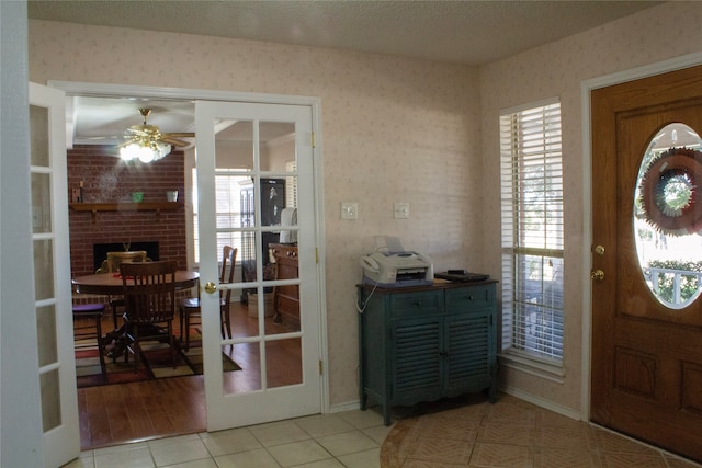 tiled foyer entrance featuring french doors and ceiling fan