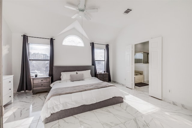 bedroom featuring ensuite bathroom, vaulted ceiling, and ceiling fan