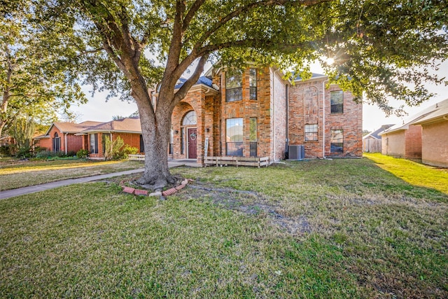 view of front of property with central AC unit and a front lawn