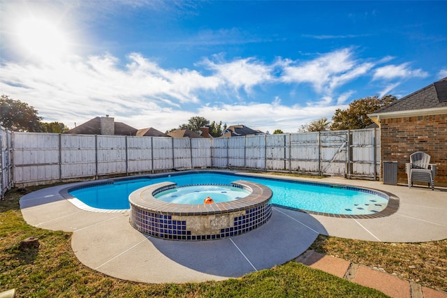 view of swimming pool with an in ground hot tub