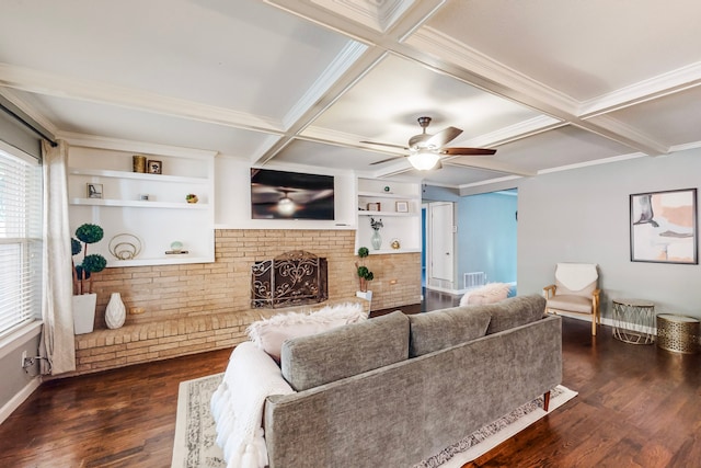 living room with dark wood-type flooring, coffered ceiling, ceiling fan, a fireplace, and beamed ceiling