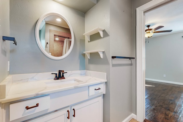 bathroom featuring hardwood / wood-style floors, ceiling fan, a shower with curtain, and vanity