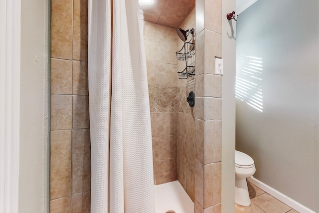 bathroom with curtained shower, tile patterned flooring, and toilet