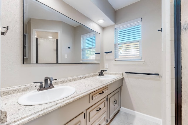 bathroom featuring vanity and an enclosed shower