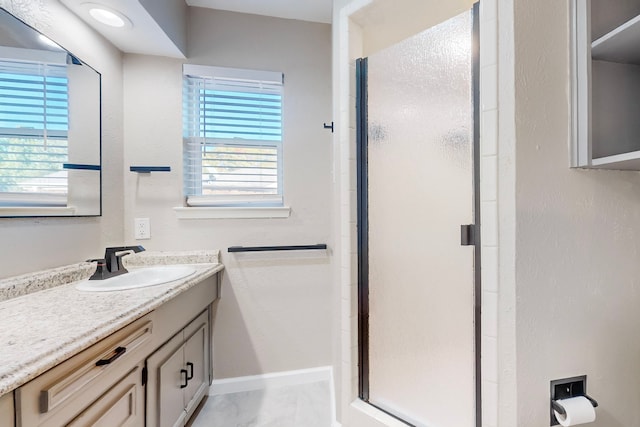 bathroom with vanity and a shower with shower door