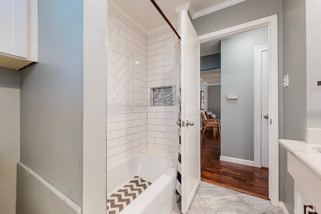 bathroom featuring vanity, hardwood / wood-style floors, tiled shower / bath combo, and crown molding