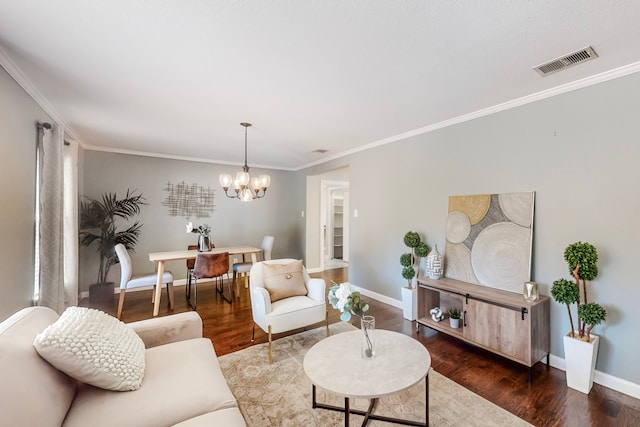 living room with dark hardwood / wood-style flooring, an inviting chandelier, and ornamental molding