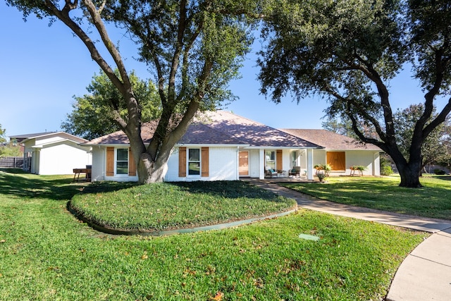 single story home with a front yard and a garage