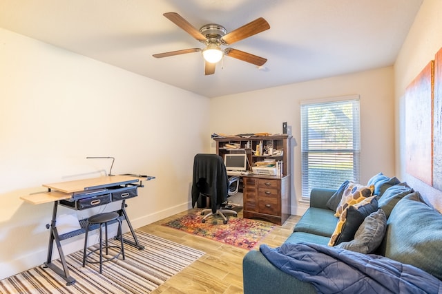 office with ceiling fan and light hardwood / wood-style floors