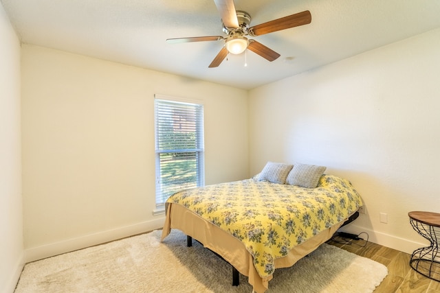 bedroom featuring ceiling fan and light hardwood / wood-style flooring