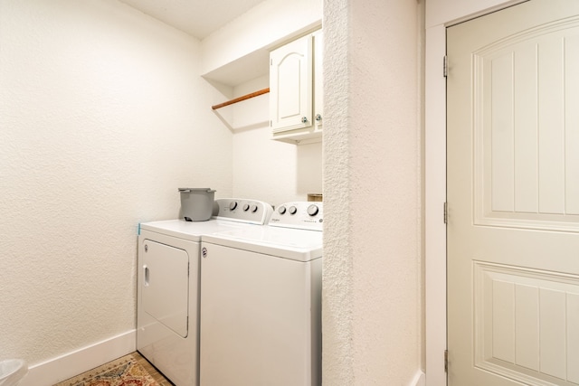 laundry area with washer and dryer and cabinets