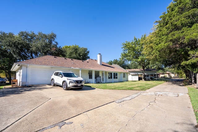 single story home with a garage and a front yard