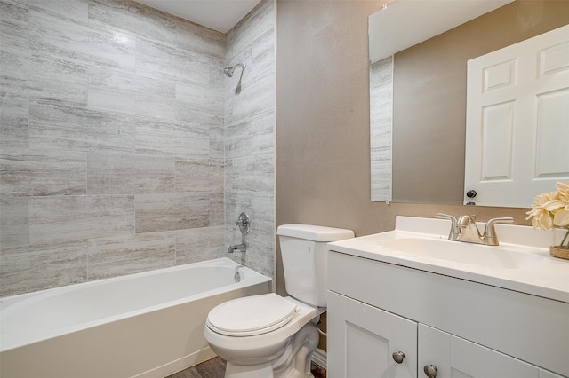 full bathroom with toilet, vanity, and tiled shower / bath combo