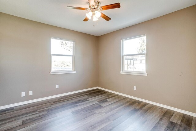 empty room featuring ceiling fan, plenty of natural light, and hardwood / wood-style flooring