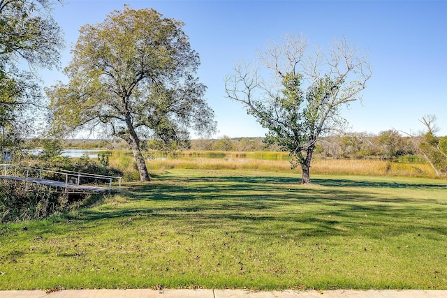 view of yard featuring a rural view and a water view