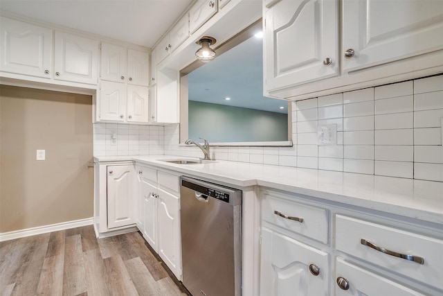 kitchen featuring backsplash, dishwasher, white cabinets, and light hardwood / wood-style flooring