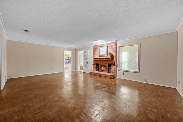 unfurnished living room featuring a fireplace, dark parquet floors, a textured ceiling, and ornamental molding